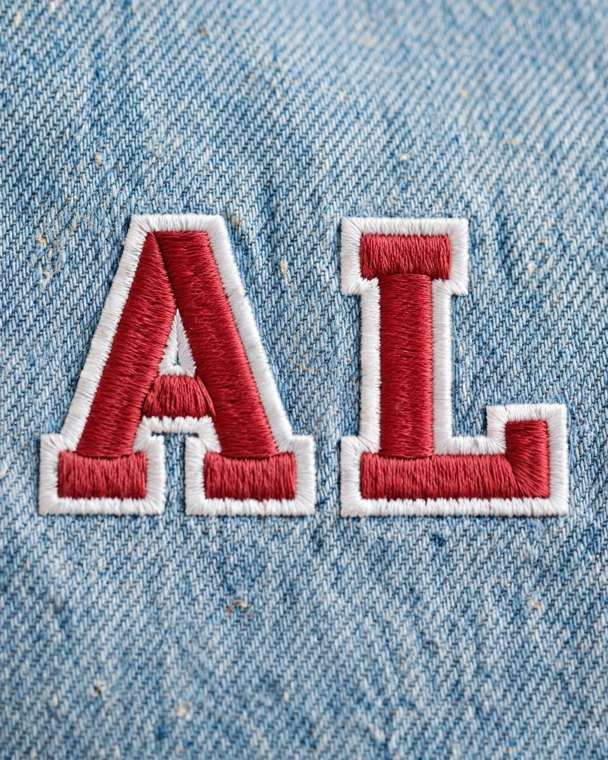 Light denim tote with small red patch letters – embroidery close-up of chunky red varsity letters