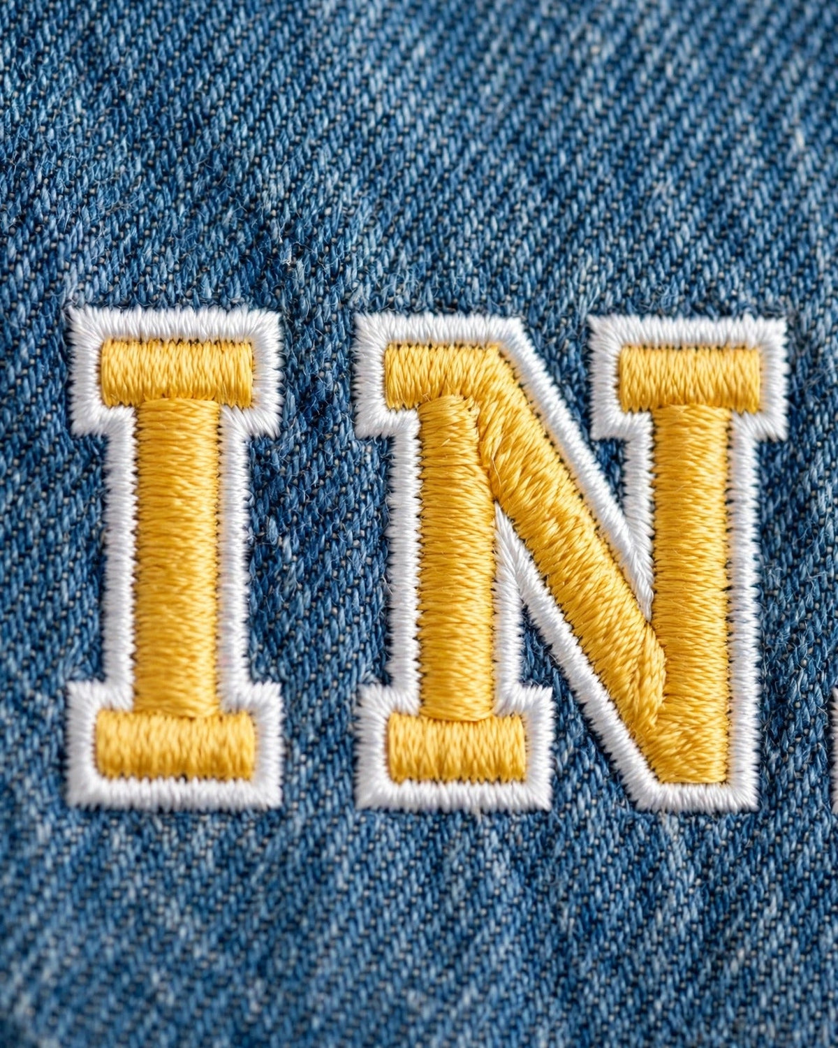 Medium denim tote with small yellow patch letters - embroidery close-up of letters