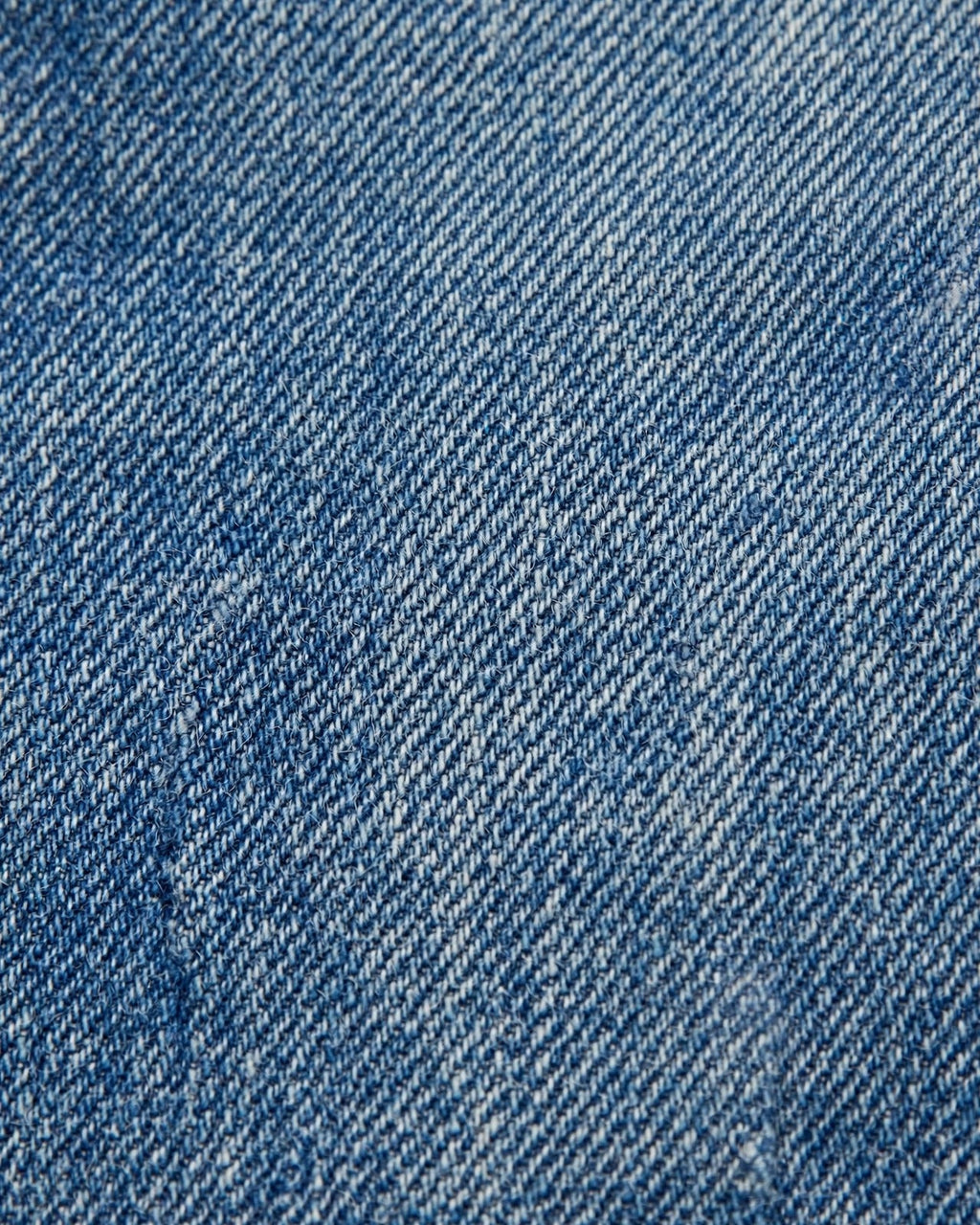 Medium denim tote with small yellow patch letters - denim fabric texture close-up