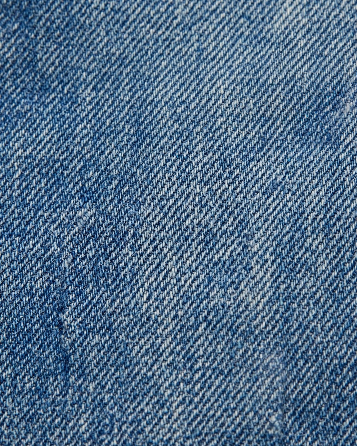 Medium denim tote with small yellow patch letters - denim fabric texture close-up