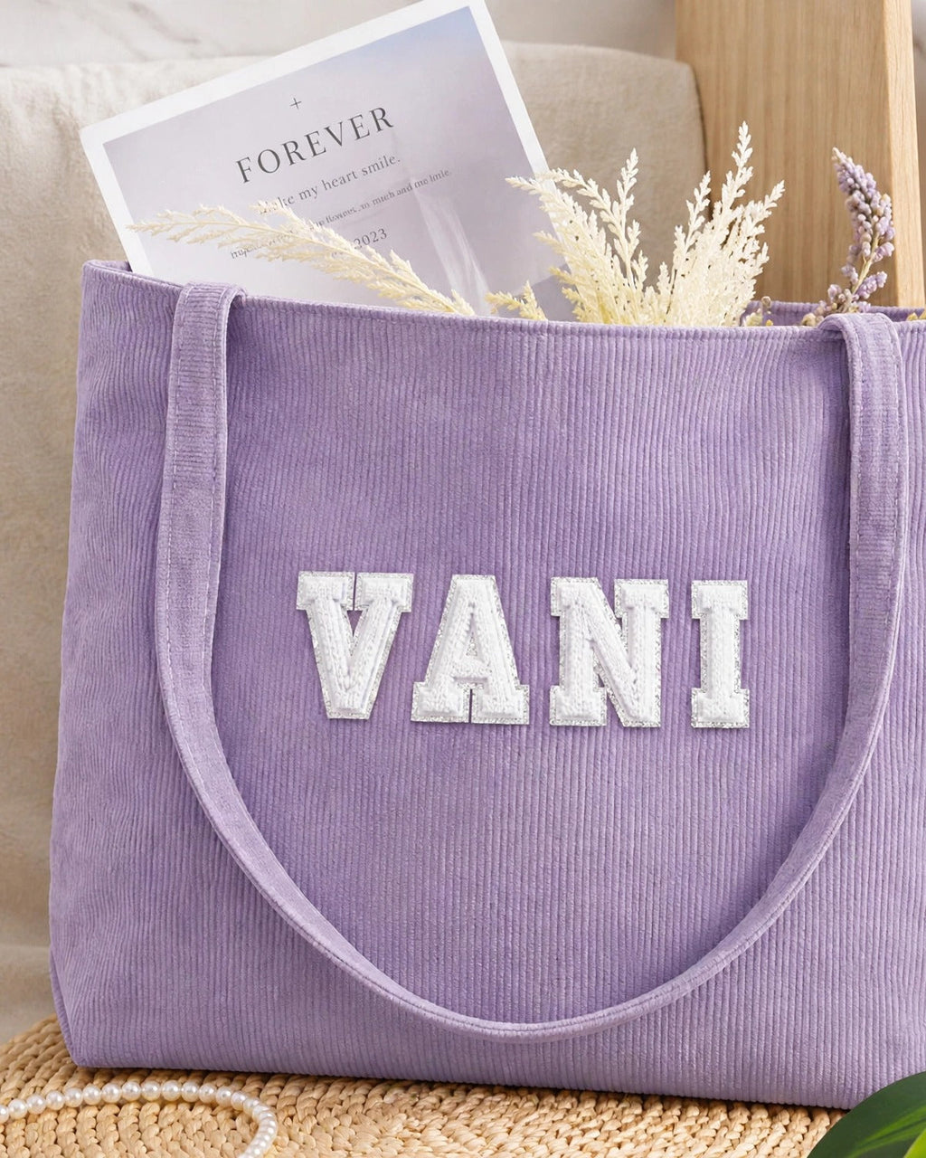 Lavender corduroy tote with VANI in white embroidered varsity patch letters