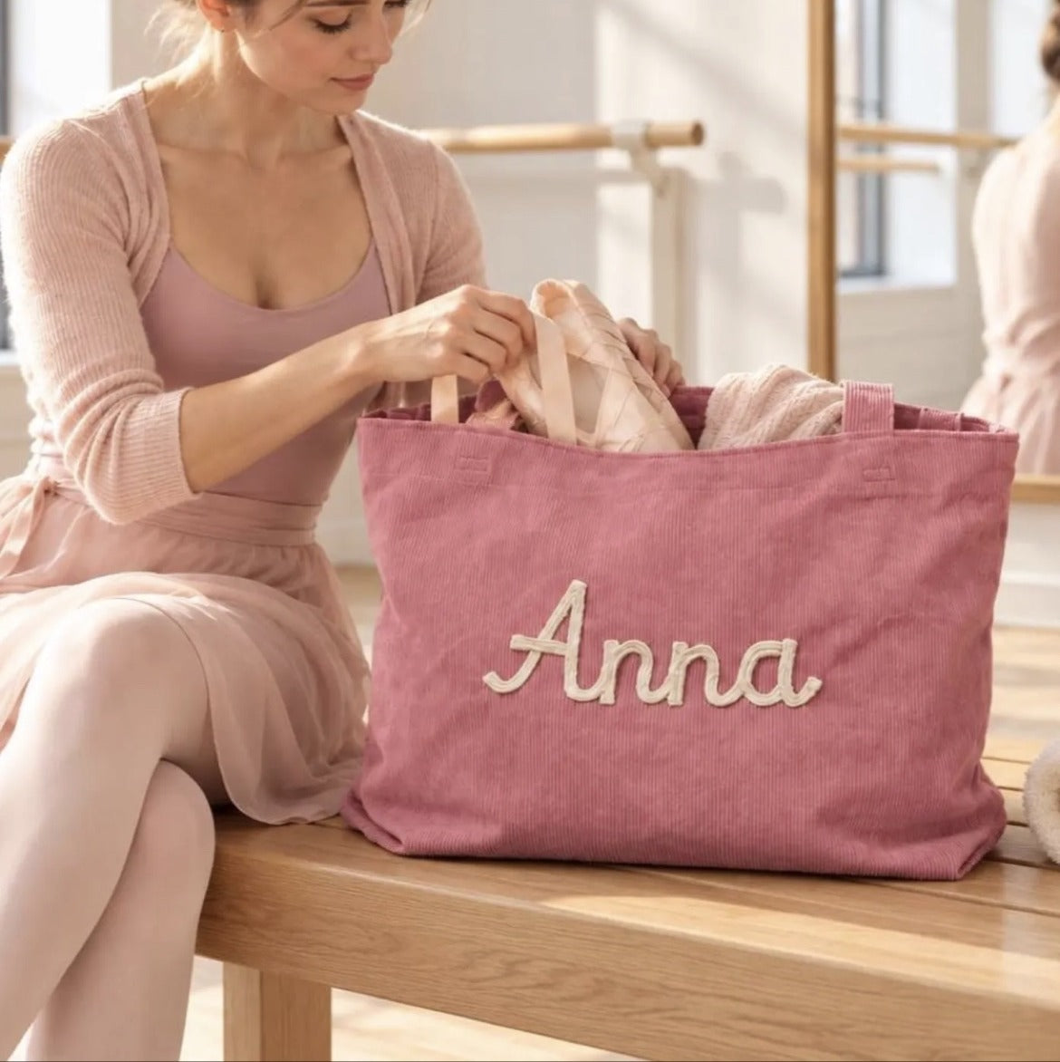 Model carrying a custom embroidered corduroy tote bag
